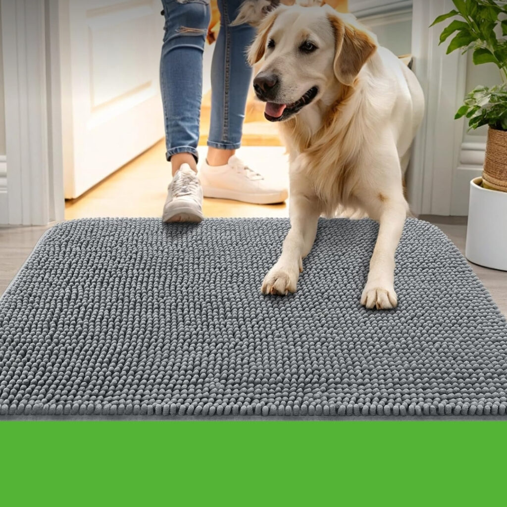 A muddy golden retriever standing on a dog door mat inside an entryway | HappyBarker